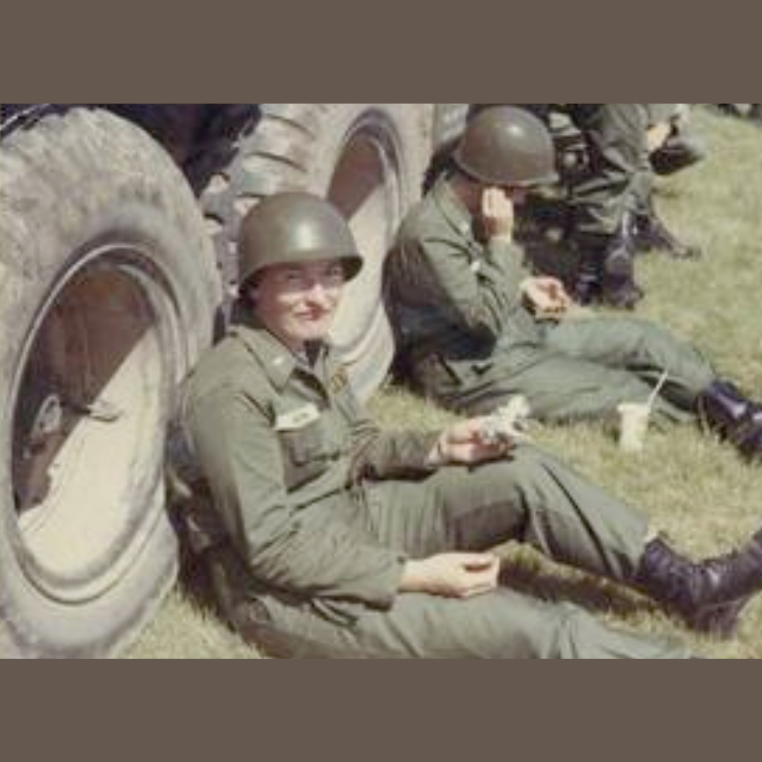 Photo of men in army leaning against a large truck